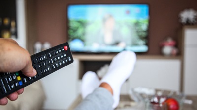 person holding tv remote