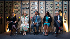 Sophie Wessex holding the microphone and speaking on a panel alongside Orbis representatives 