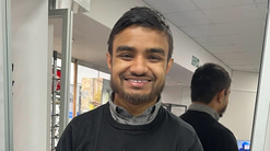 Head and shoulders shot of Raf Islam smiling
