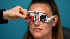 Young woman looking through trial frames