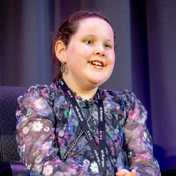 Betsy Griffin sitting on stage during the Braille 200 panel