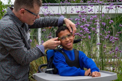 Martyn pictured fitting a patient’s spectacles