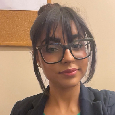 Fahima is wearing a Specsavers uniform in a head and shoulders shot