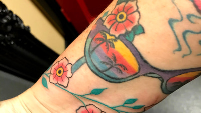 A tattoo of colourful sunglasses