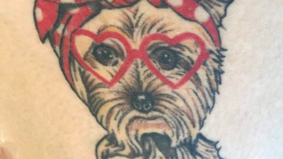 A tattoo of a dog wearing spectacles