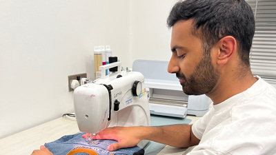 Akshay Shah is shown sewing