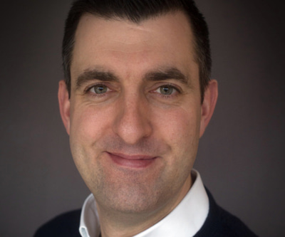 Joe Huntford wears a white shirt and black jumper