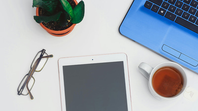 A layout of a laptop, tablet, and spectacles