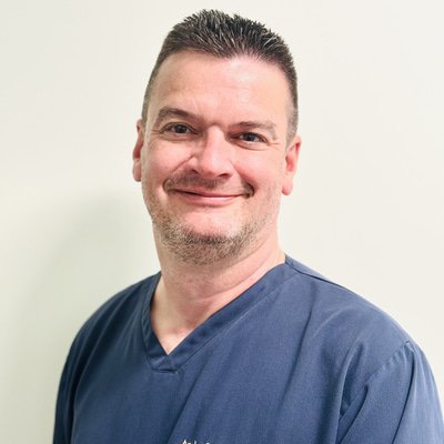 Andy Britton man smiling wearing a blue shirt