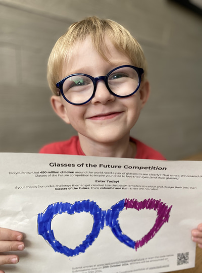 A blue wearing blue glasses holds up a colouring sheet showing blue and purple heart-shaped glasses