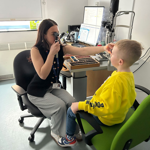 Emily tests the vision of a paediatric patient 