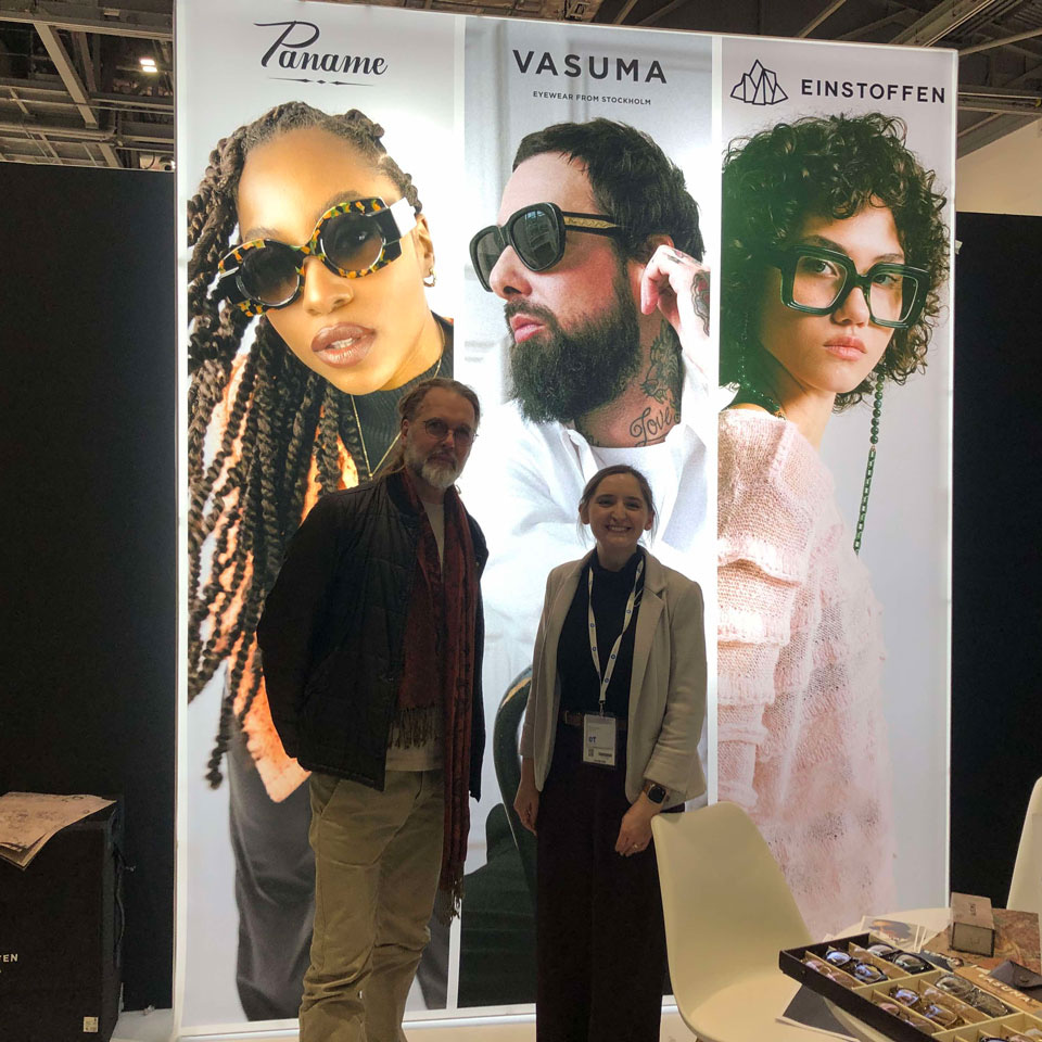 Lars and OT’s Kimberley stand in front of a display for Vasuma Eyewear on a stand at 100% Optical 