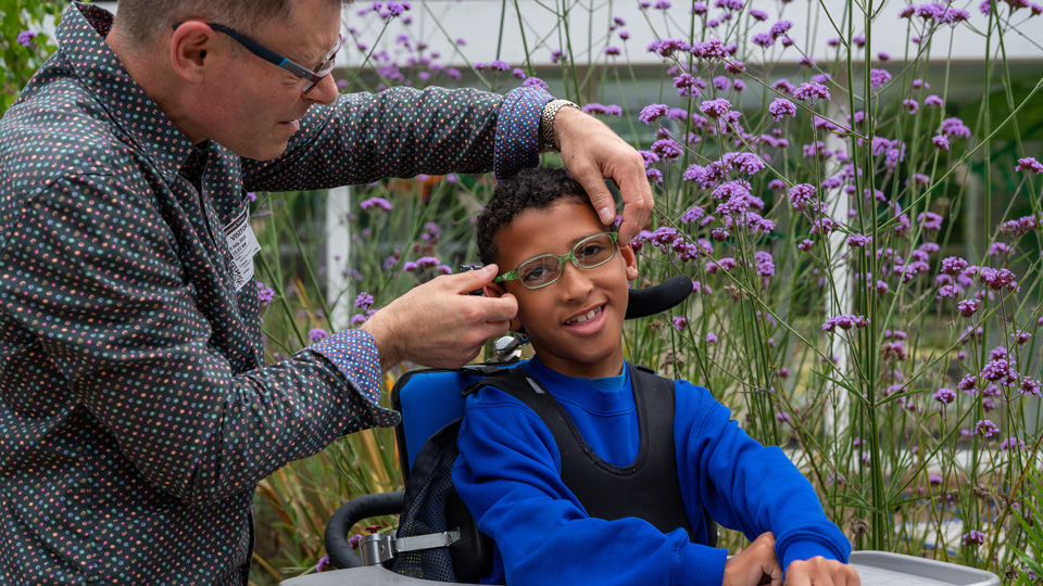 Eli being fitted with spectacles