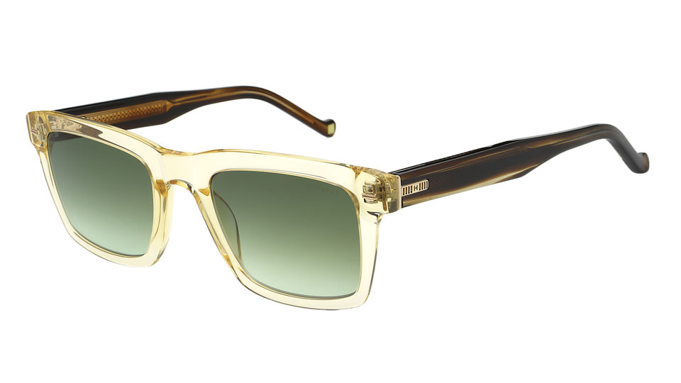 Sunglasses with a translucent front and tortoiseshell sides with a grill-like metal detail in gold. Inside of the temples the gold metal core has a delicate design