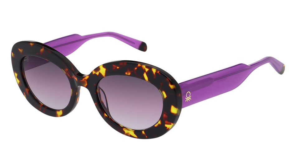 A chunky oval frame with a leopard-print style front around purple lenses, and vividly bright thick purple sides