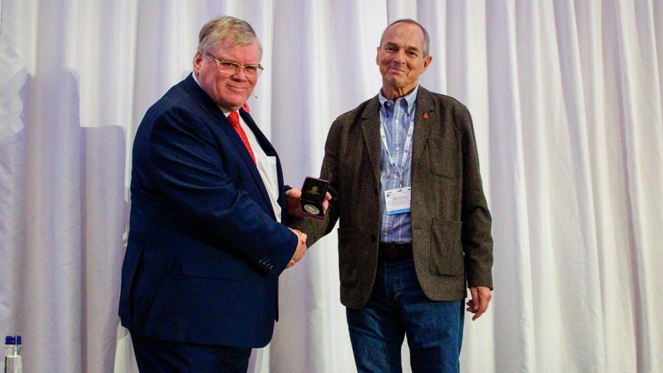 AOP Hospital Optometry Committee secretary Andrew Tompkin receiving the Woodward memorial medal from Martin Rubinstein
