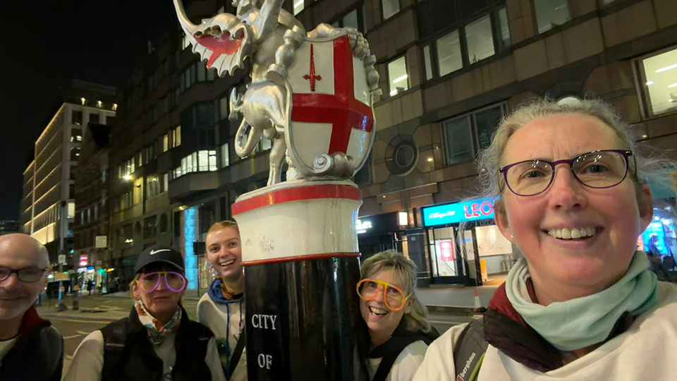 Five walkers gather around a landmark for the City of London