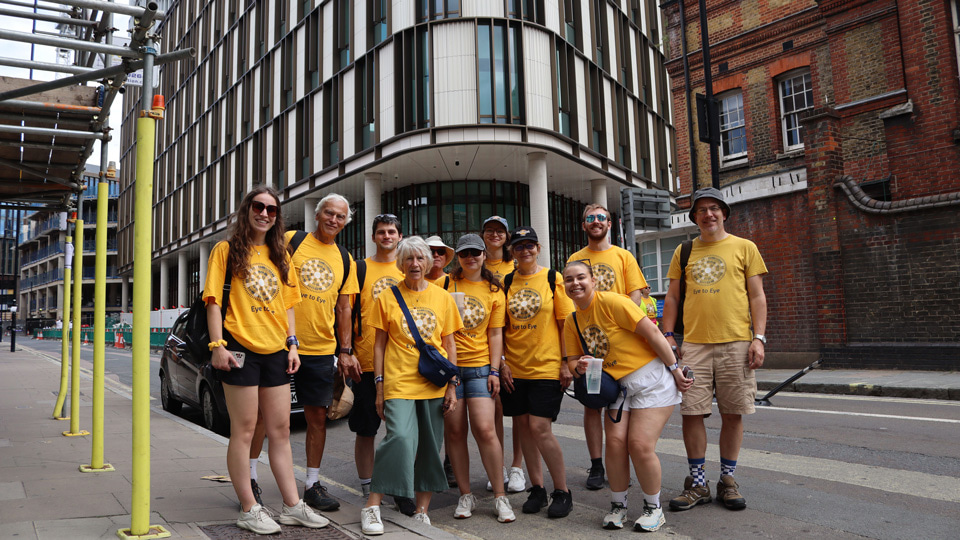 A group of participants stand outside the new Moorfields UCL building during the walk