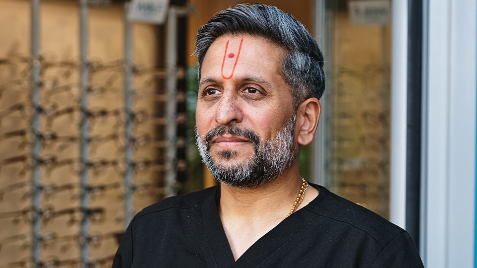 Dr Keyur Patel standing outside Tompkins, Knight and Son Optometrists 