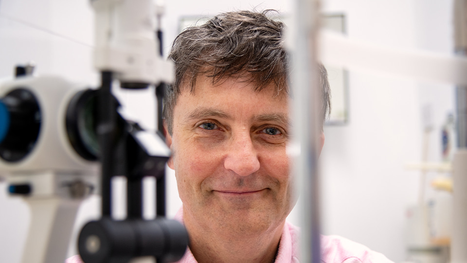 David Cummins photographed in the testing room of PLM Optometrists