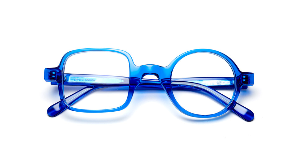 A spectacle frame in blue crystal acetate with an asymmetrical design – one lens is square and the other circle.