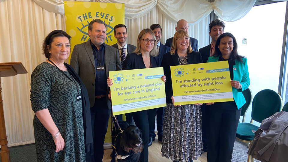 A group of people a part of The Eyes Have It campaign holding campaign posters