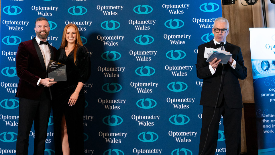 Kimberley wears a long black dress and receives a trophy