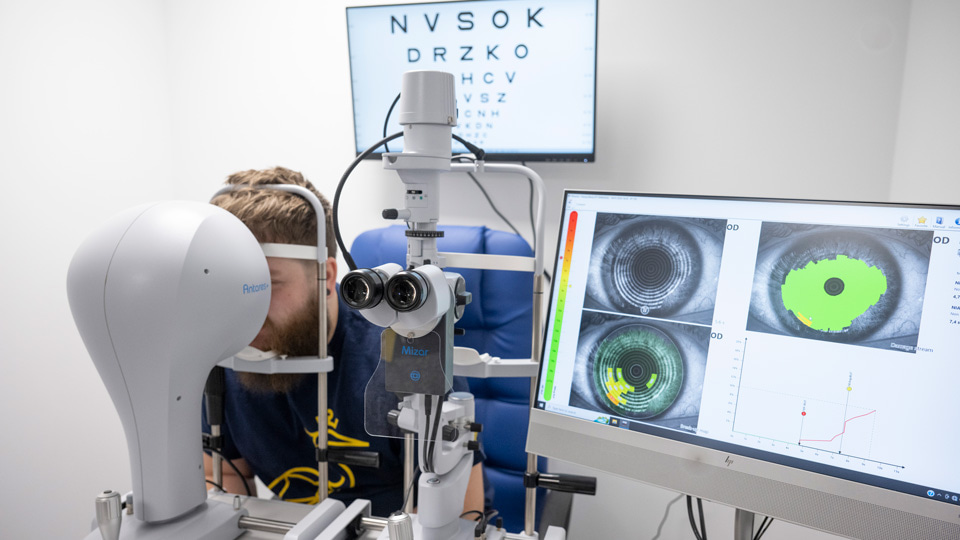 A student is positioned to have a test completed on a slit lamp in one of the new optometry research labs at ARU