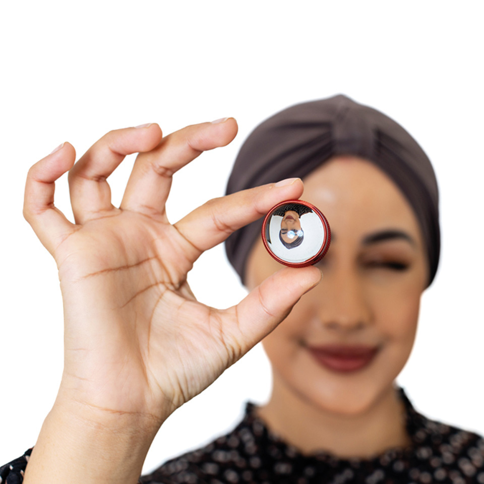 Woman holding a volk lens 