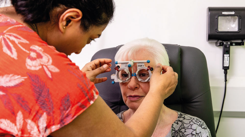 Bhavina Patel puts a trial frame on a patient