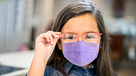 girl wearing glasses and face mask