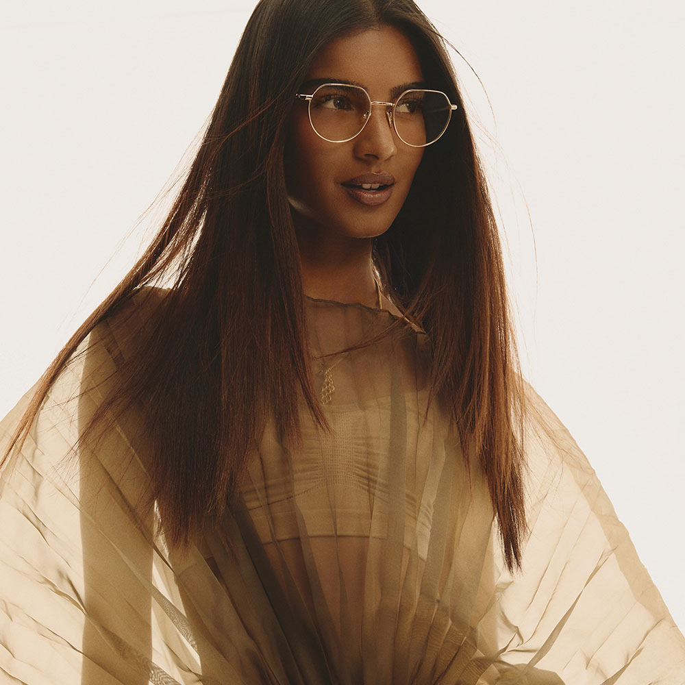 A model wears thin metal frames that catch the light