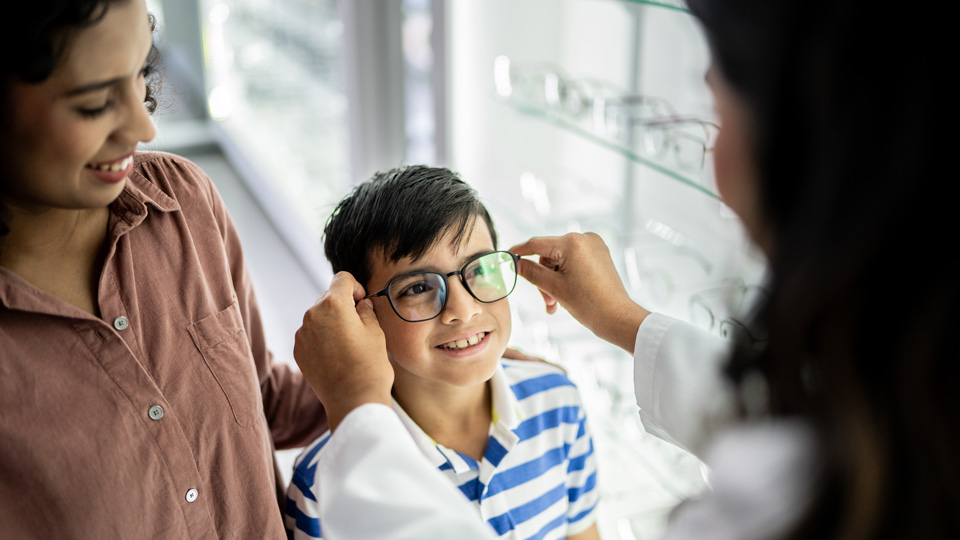Boy trying on glasses