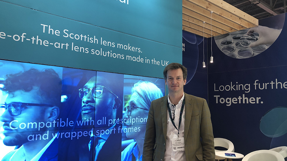 Mat, wearing a green tweed jacket, on the Caledonian Optical stand at 100% Optical