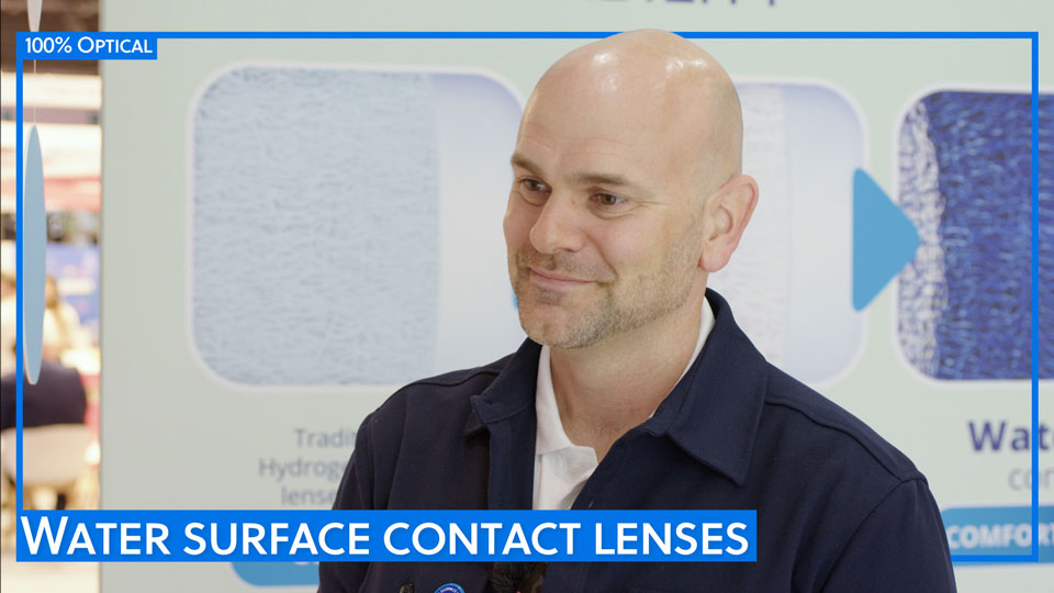  Jason stands by an illustration of the water surface lenses at Alcon’s 100% Optical stand