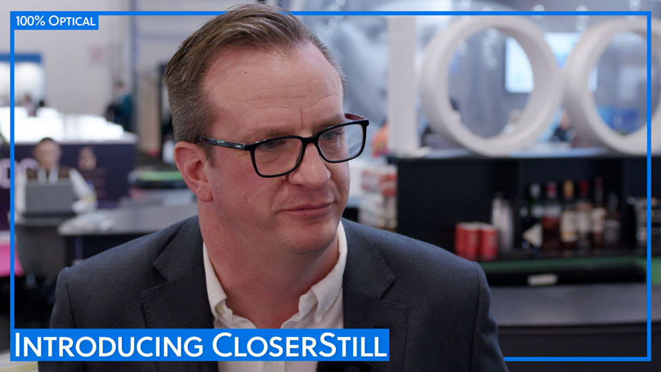 A still from an interview with Rob Chapman – behind him is a sign for 100% Optical 