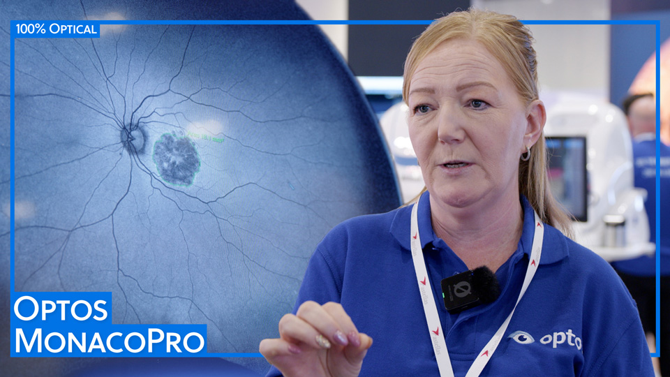Sharon Ormonde, in a royal blue polo shirt, provides a demonstration on the Optos stand at 100% Optical