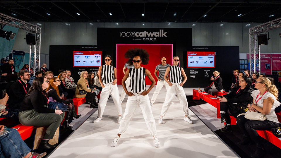 Three models pose on the catwalk at 100% Optical