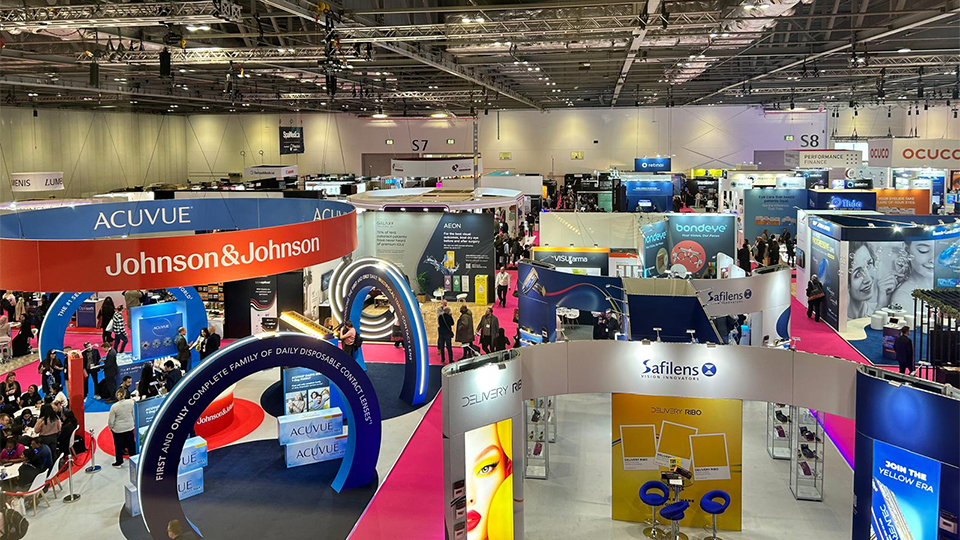 A view of an exhibition hall from above. Stands include Johnson and Johnson, Safilens, Ocuco. The effect is busy and bustling