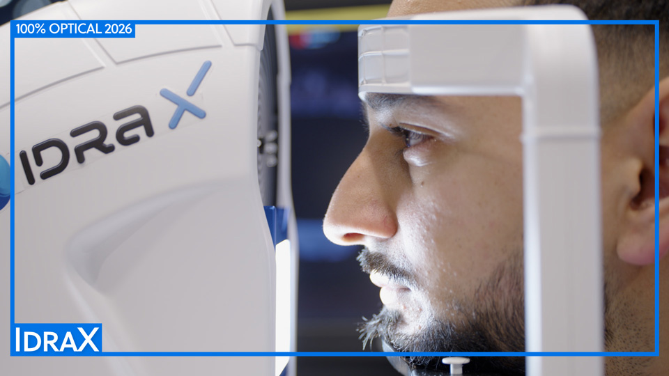 A man is positioned for a dry eye assessment with the Idra X device, a sleek white machine with grey and blue logo