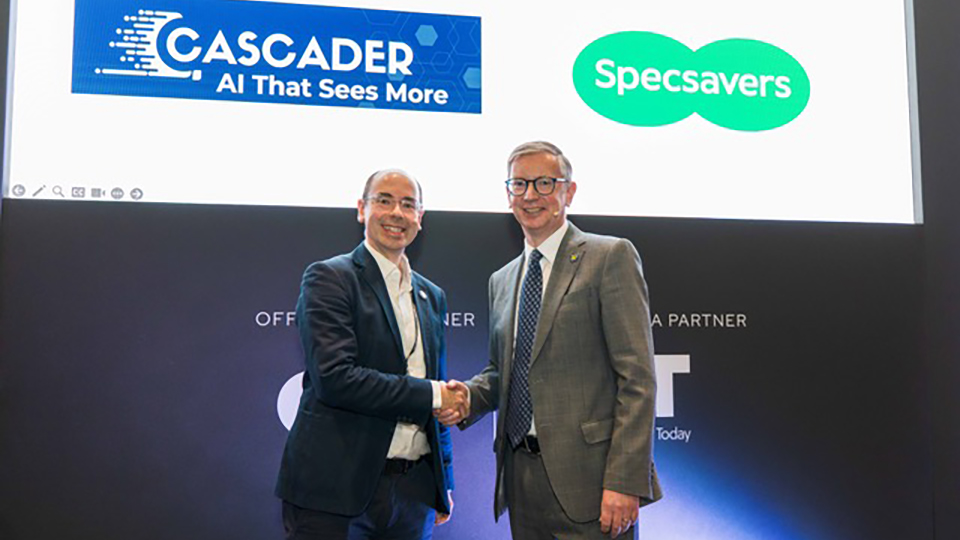Peter Thomas and Giles Edmonds shake hands on stage at 100% Optical