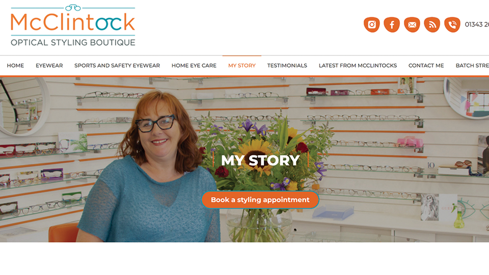 Screenshot of a website showing a woman smiling in front of a wall of glasses frames