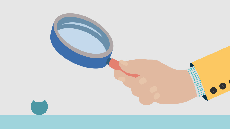 A magnifying glass is held over a contact lens