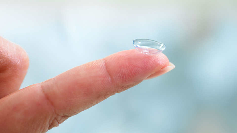 A contact lens on a finger