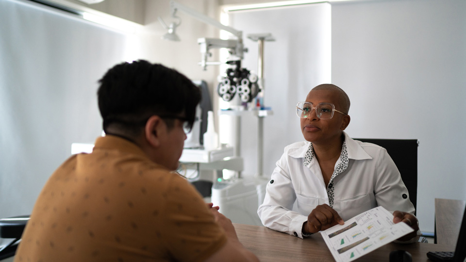 An optometrist explains results to a patient