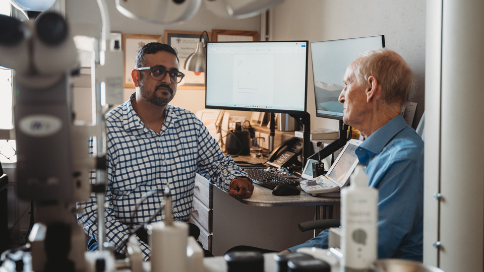 Ankur Trivedi standing talking to Paul Tyler 