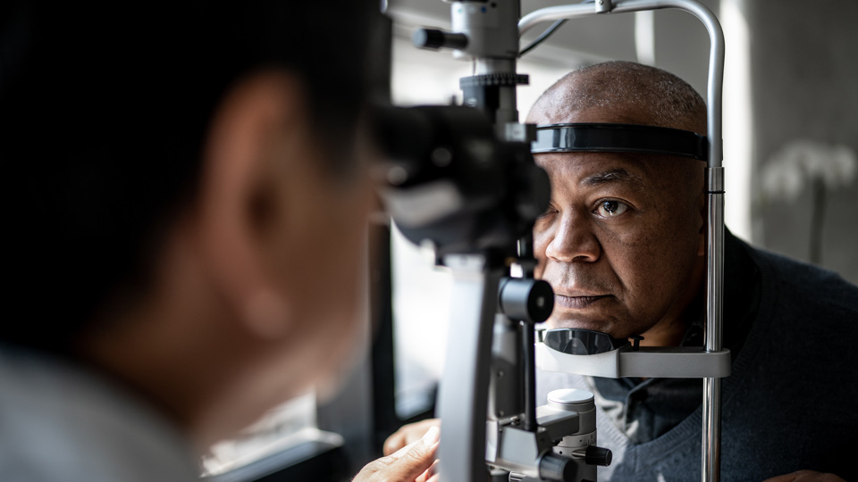 An older gentleman is having an eye test