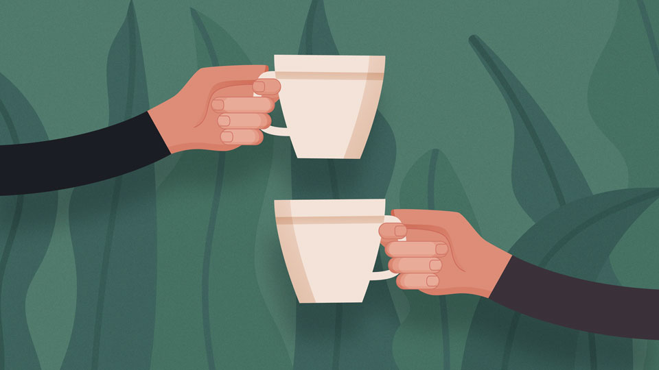 Two hands holding a cup against a green background