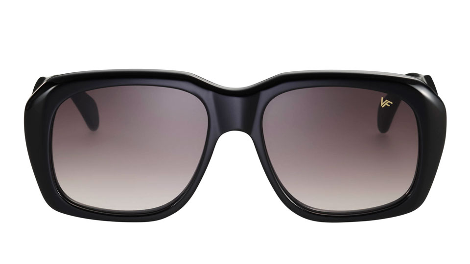 A pair of sunglasses with an oversized black frame, softly bevelled edges giving it a rounded look, and gradient brown lenses 