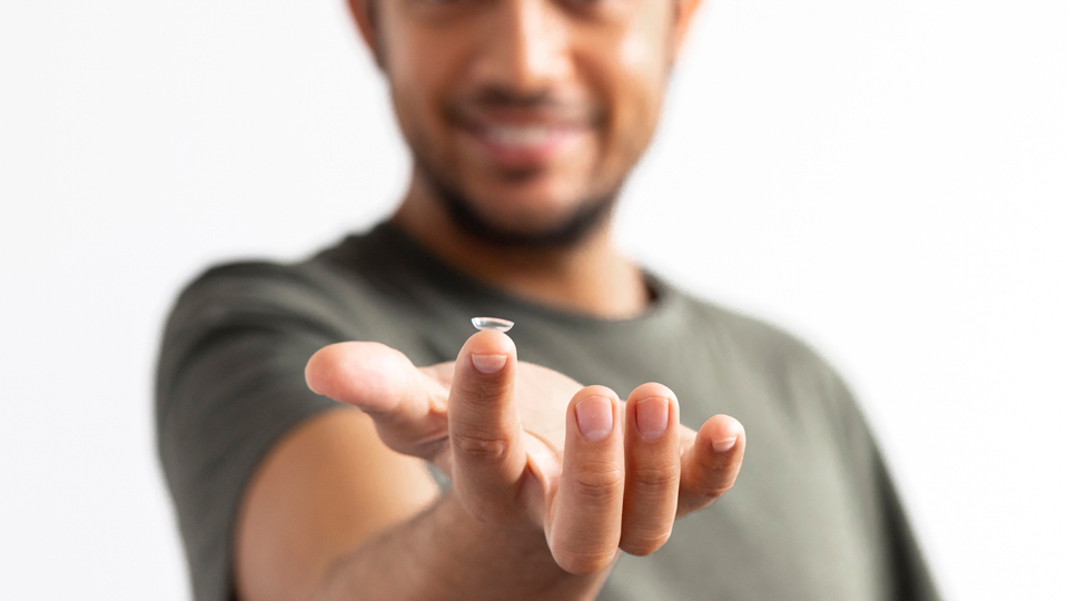 A contact lens on a finger  